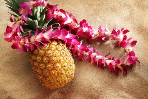 lei on pineapple at the beach
