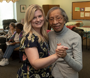 Resident dancing with care taker